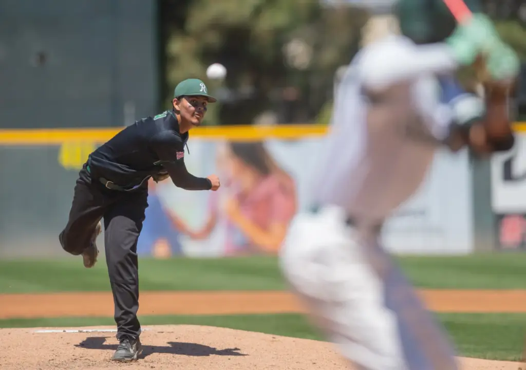 Rancho Alamitos, pitcher Henry Garcia, (#3), delivers a pitch to...