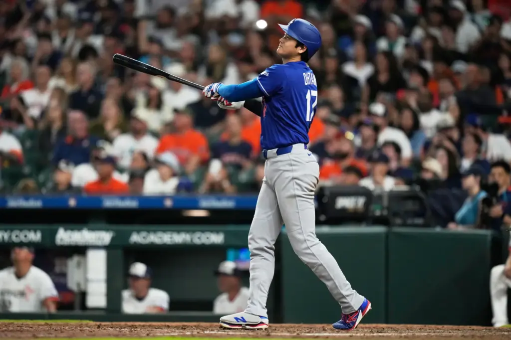 Dodgers designated hitter Shohei Ohtani watches his fly ball for...