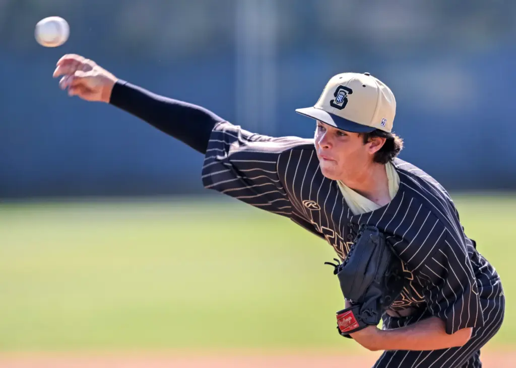 Servite starting pitcher Cole Grosthues throws to home plate during...