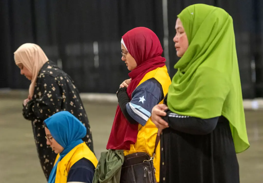 Women pray during the celebration of the Muslim holiday Eid...