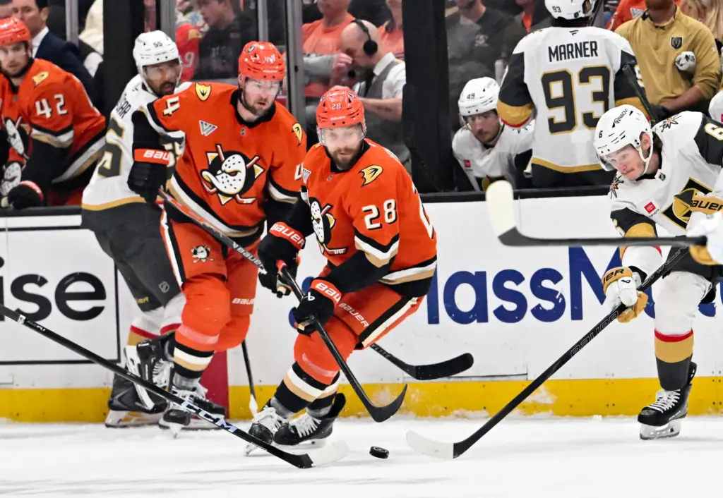 The Ducksâ Ross Johnston (44) and Jeffrey Viel (28) pursue...