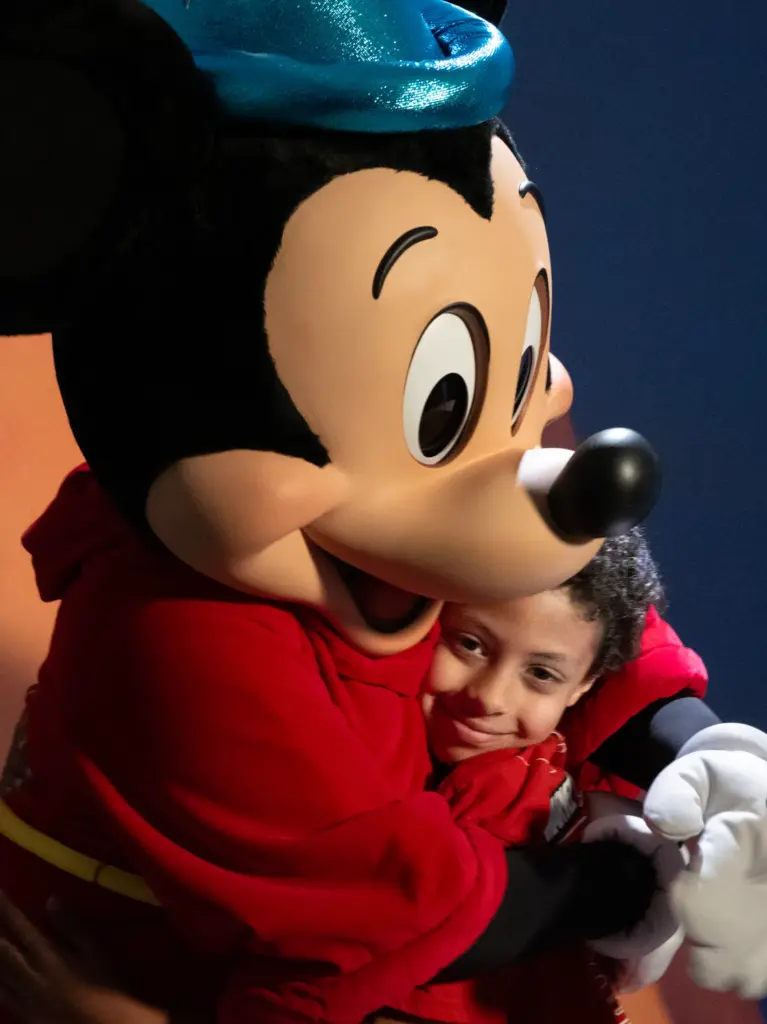 Eight-year-old Jordan Mosley gets a hug from SorcererÂ Mickey on Wednesday,...