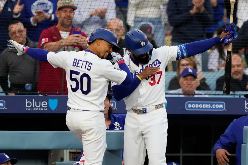 The Dodgers’ Mookie Betts, left, and teammate Teoscar HernÃ¡ndez celebrate...