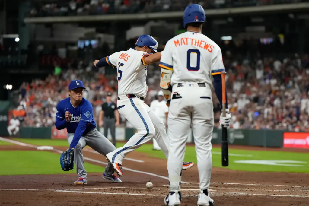 The Houston Astros’ Isaac Paredes (15) scores ahead of a...