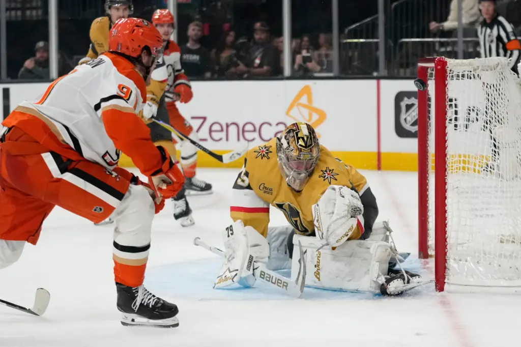 Ducks center Leo Carlsson, left, scores against Vegas Golden Knights...
