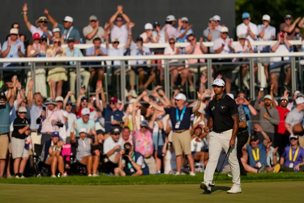 Aaron Rai, of England, celebrates after his shot on the...