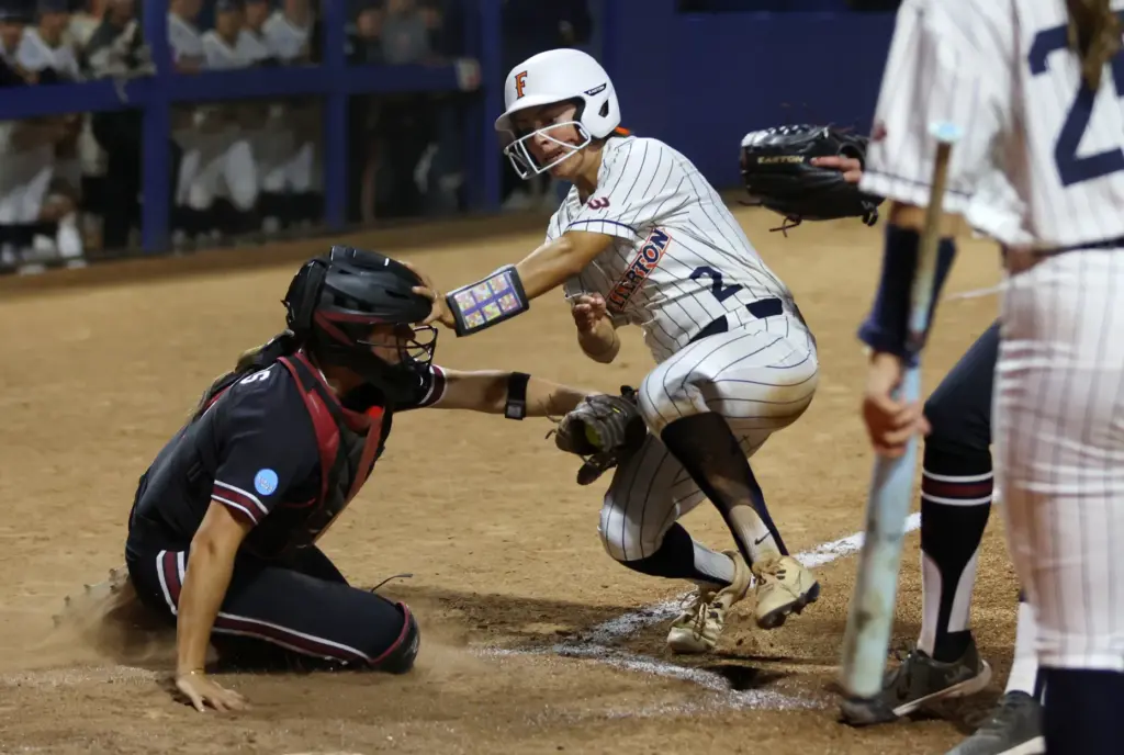 Cal State Fullertonâs Sarah Perez (2) is tagged out by...