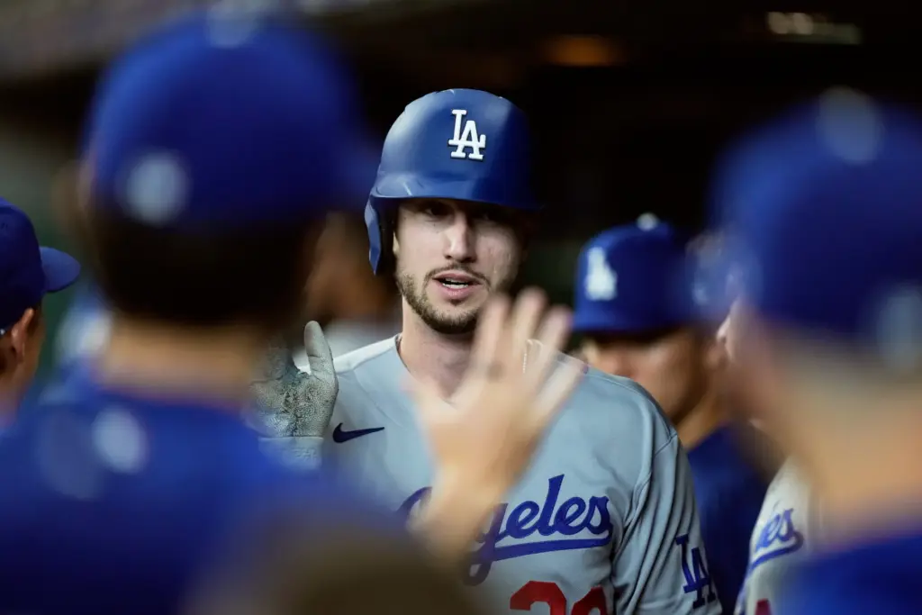 The Dodgers’ Kyle Tucker celebrates in the dugout after scoring...