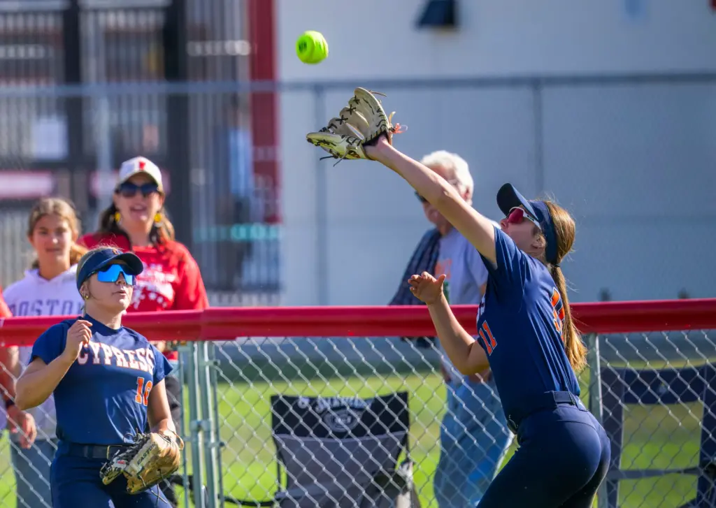 Cypress’ Hayden Warner, right, makes the catch on a drive...