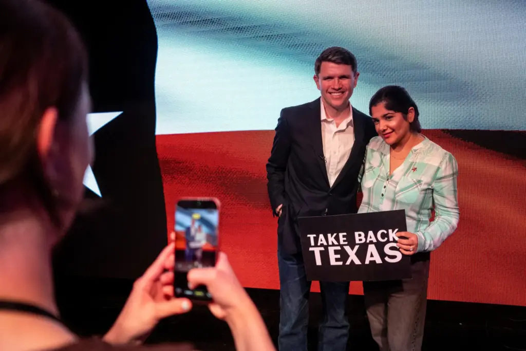 Democratic Senate candidate James Talarico takes a photo with a supporter during a rally in Houston.
