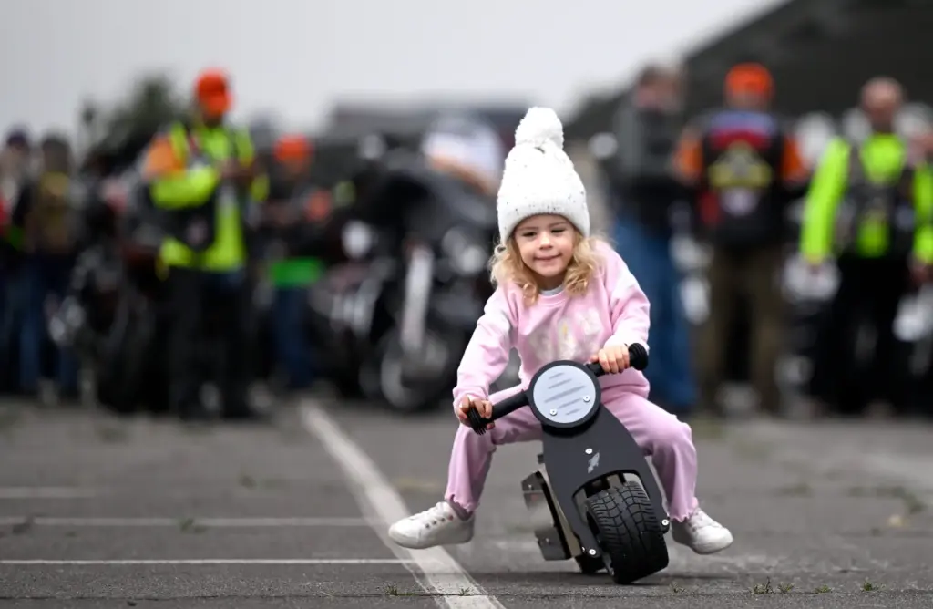Olivia Meyer, 3, from Placentia, pushes her toy motorcycle throught...