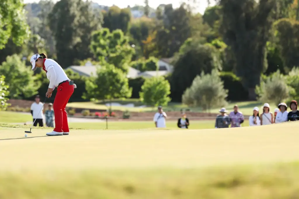 Sei Young Kim putts from the green on the seventeenth...