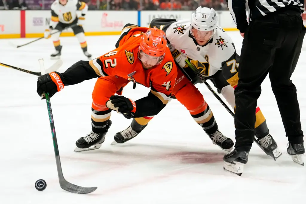 Ducks center Tim Washe, left, and Vegas Golden Knights center...