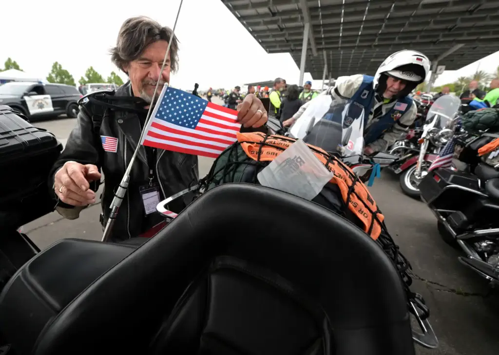 ,Claude âSwissmanâ Nicolet, 71 from Pinetop, Arizona, attaches an American...