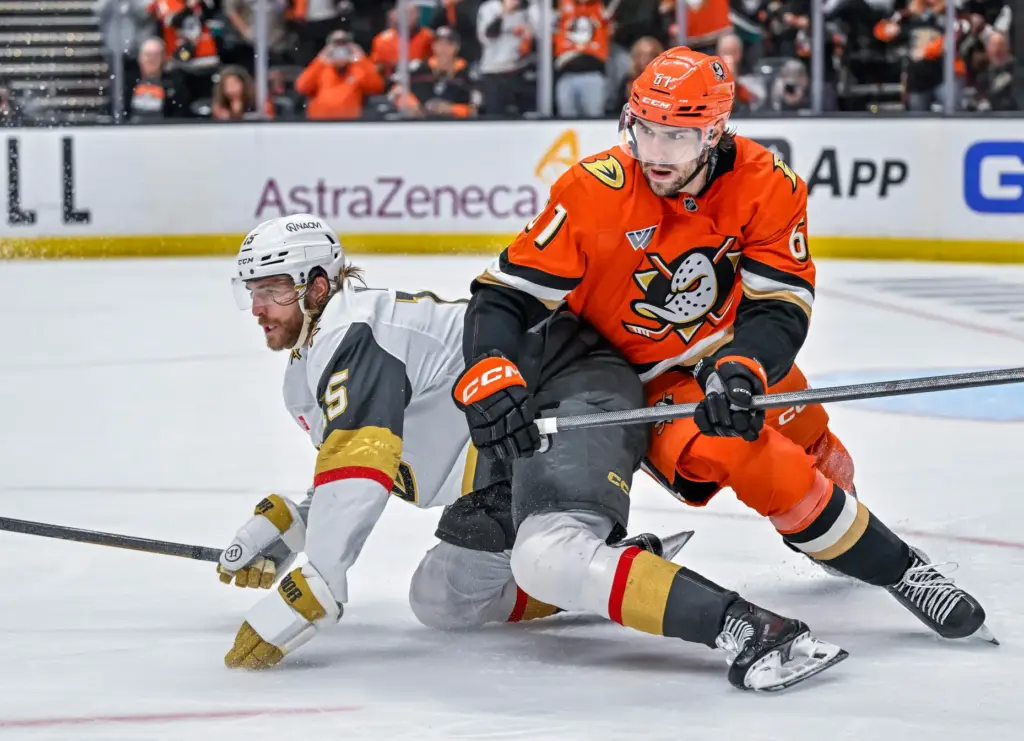 The Golden Knightsâ Noah Hanifin (15), left, and the Ducksâ...