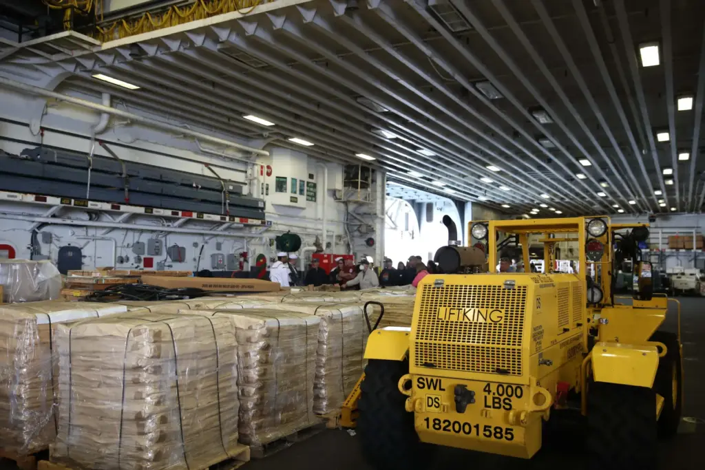 Visitors tour the Hangar Bay of the USS Essex, an...