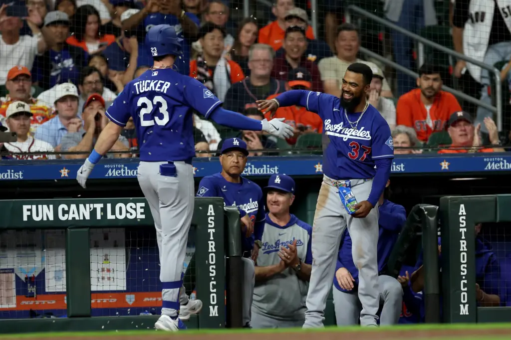 Dodgers outfielder Teoscar Hernandez, right, congratulates teammate Kyle Tucker as...