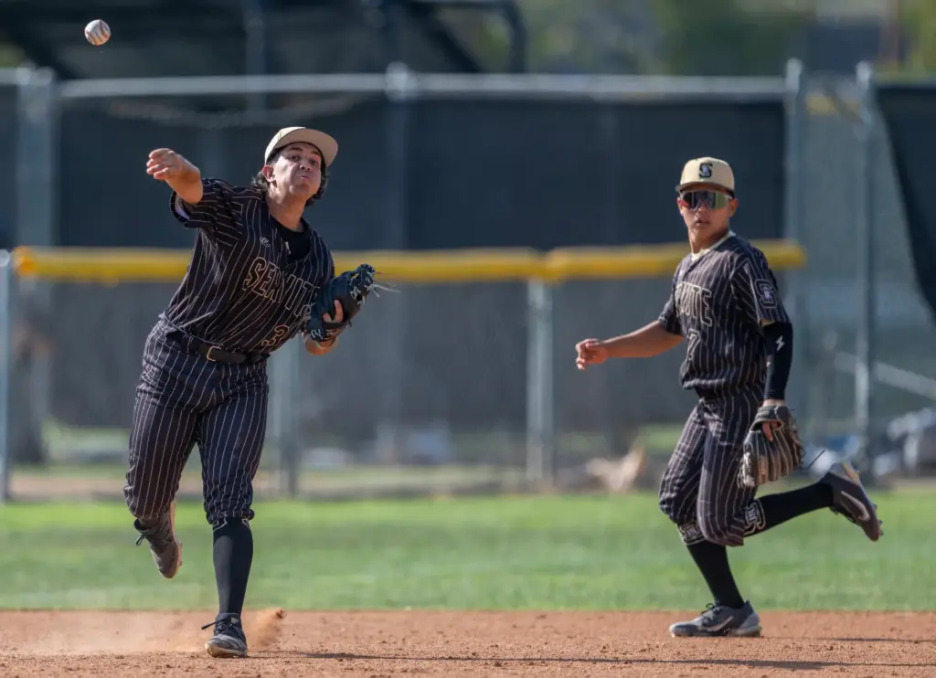 Servite third baseman PJ Becerra throws to first base after...