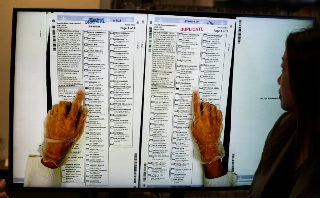 People work in ballot duplication at the Orange County Registrar...