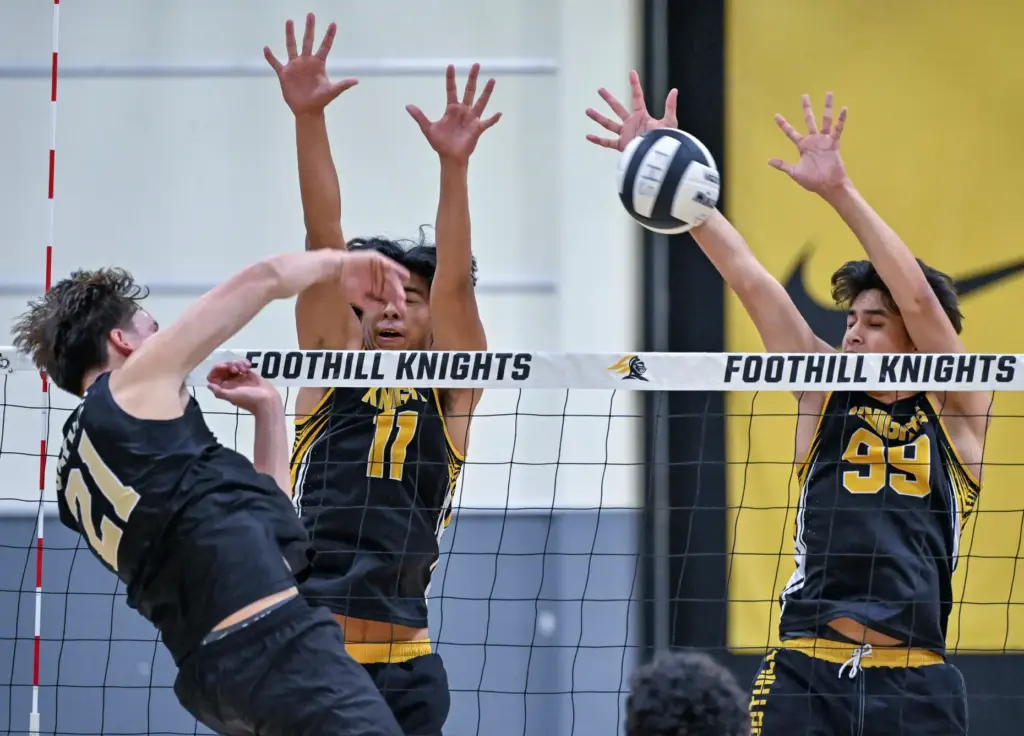 Foothillâs JJ Barraza, center, and Luas Cuellar, right, block Servite...