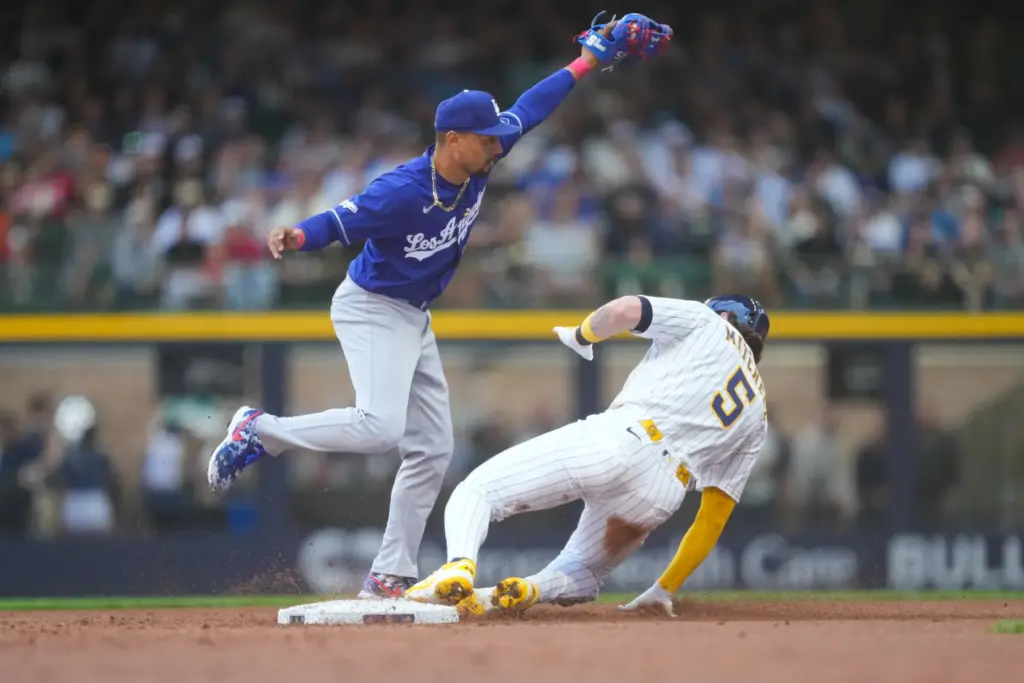 Dodgers shortstop Mookie Betts, left, forces out Milwaukee Brewers’ Garrett...