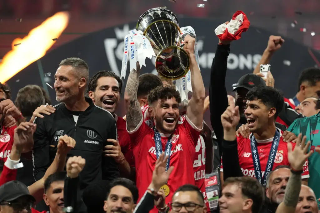 Toluca’s Jesus Angulo lifts the trophy after beating Tigres during...