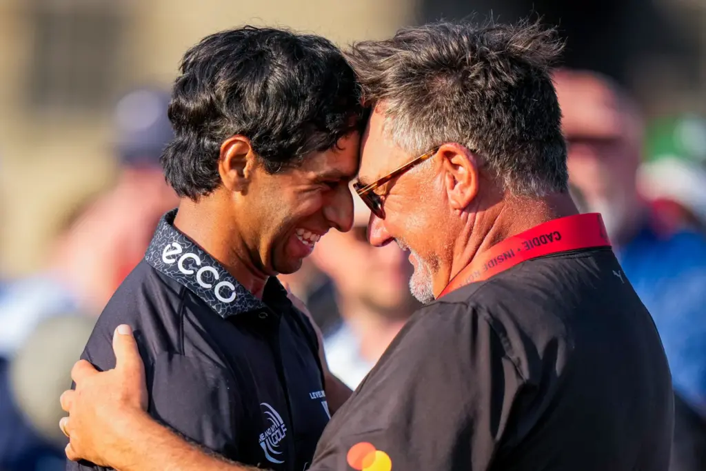 Aaron Rai, of England, left, hugs Justin Rose’s caddie Mark...
