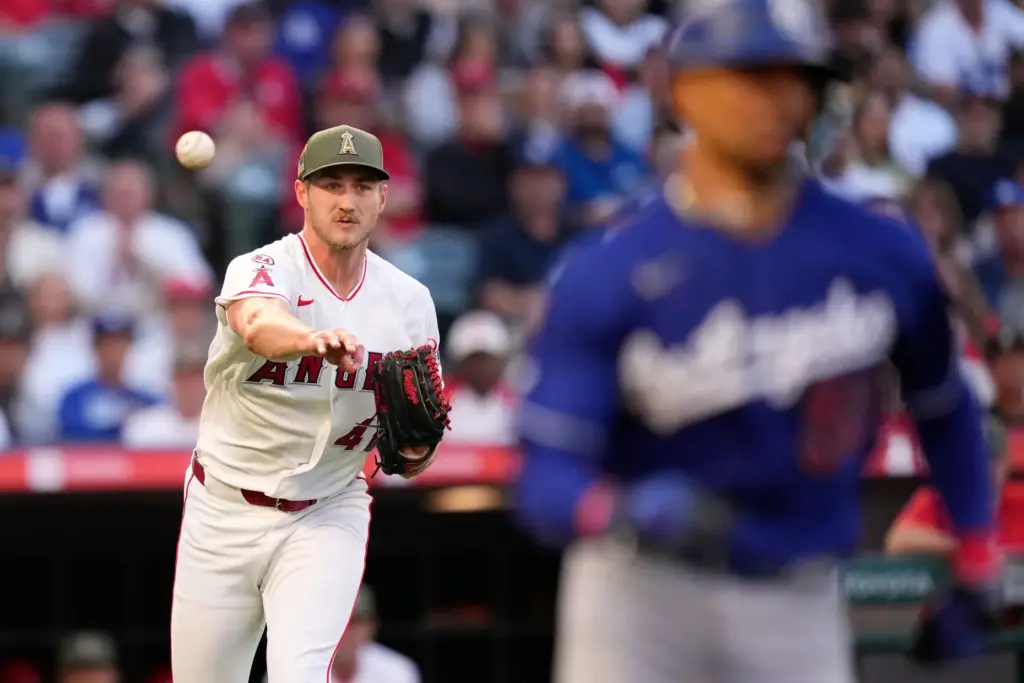 Angels starting pitcher Jack Kochanowicz, left, throws out the Dodgers’...