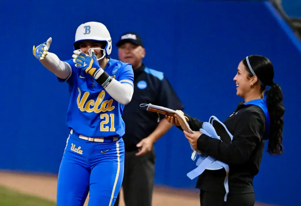 Aleena Garcia #21 of the UCLA Bruins reacts after a...