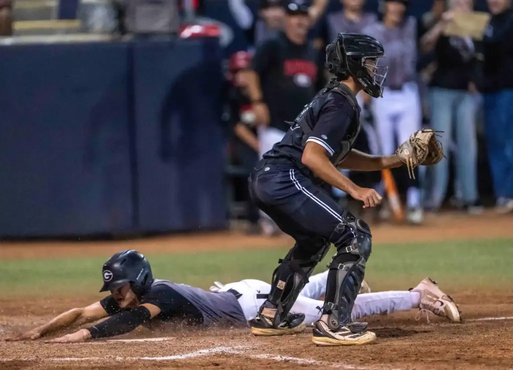 Glendora infielder Santiago Garza slides into home plate to tie...