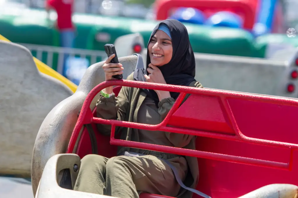 Sadia Patel of Lawndale records her ridenduring the celebration of...