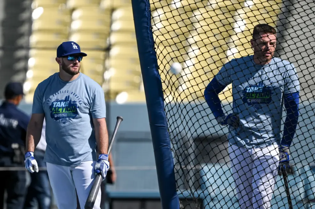 The Dodgers’ Max Muncy, left, and Freddie Freeman wait to...