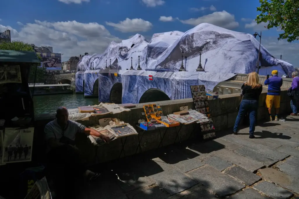 People take pictures of “The Pont Neuf Cave,” an inflated...