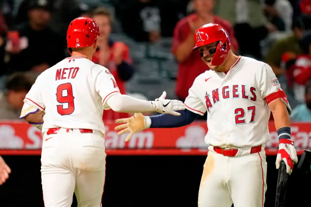 The Angels’ Zach Neto, left, is congratulated by teammate Mike...