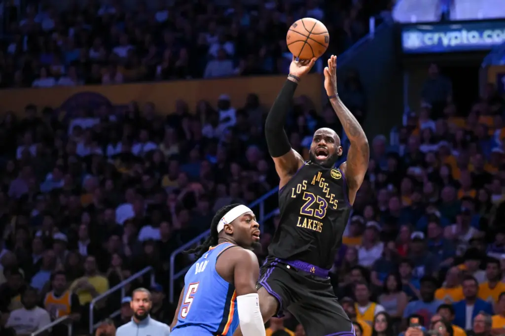 Lakers star LeBron James goes up for a shot as...