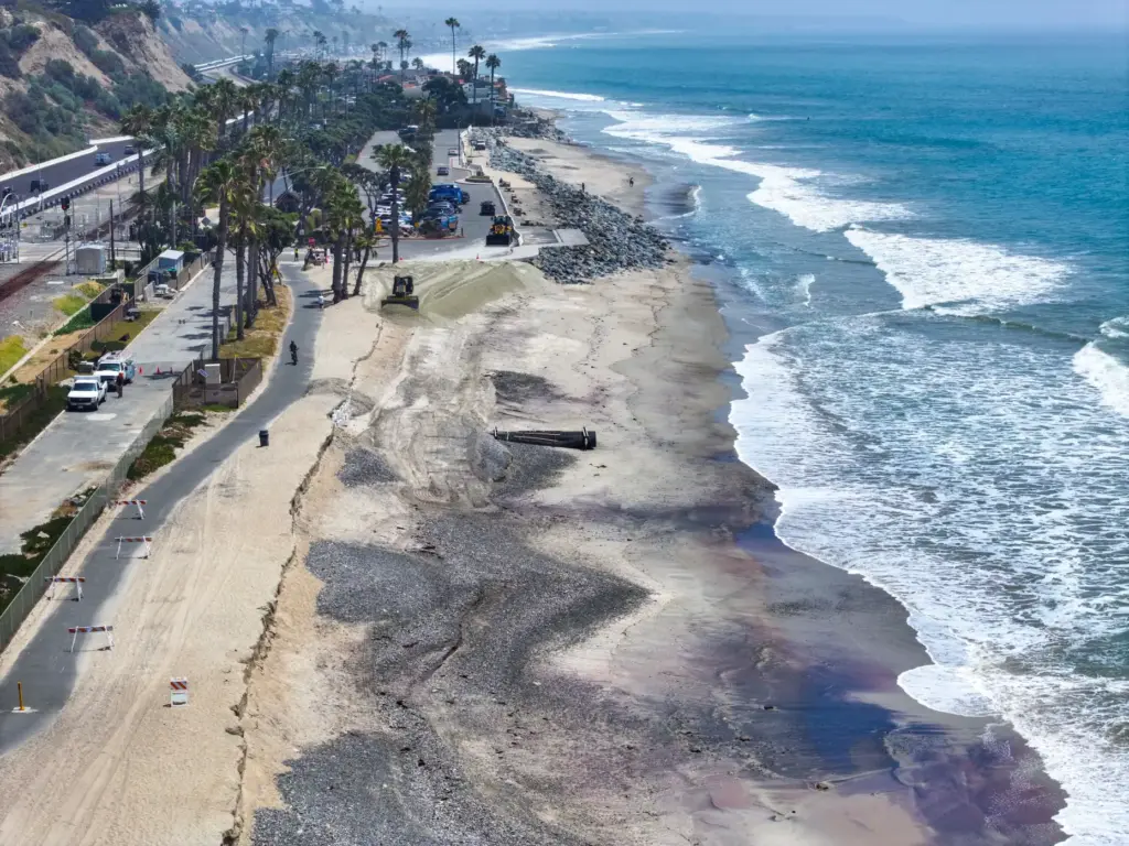 The first of 13,500 cubic yards of sand is delivered...