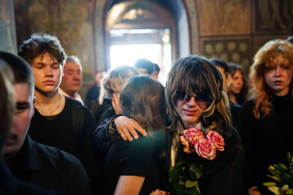 People attend the funeral of sisters Liubava and Vira Yakovlieva.