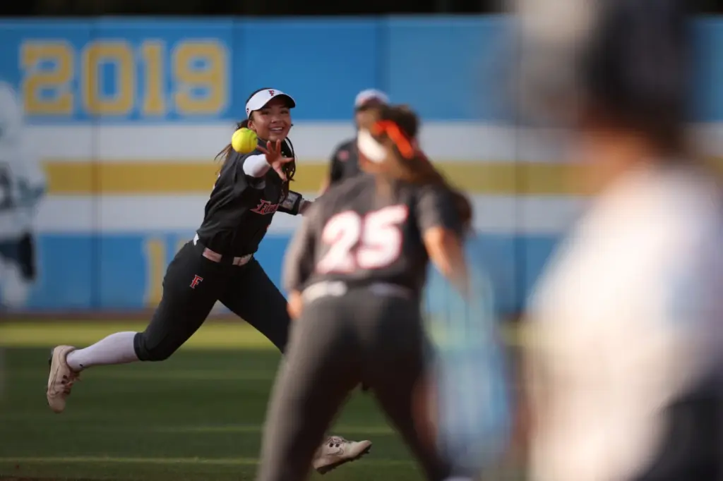 Cal State Fullertonâs Colby McClinton, left, tosses the ball to...
