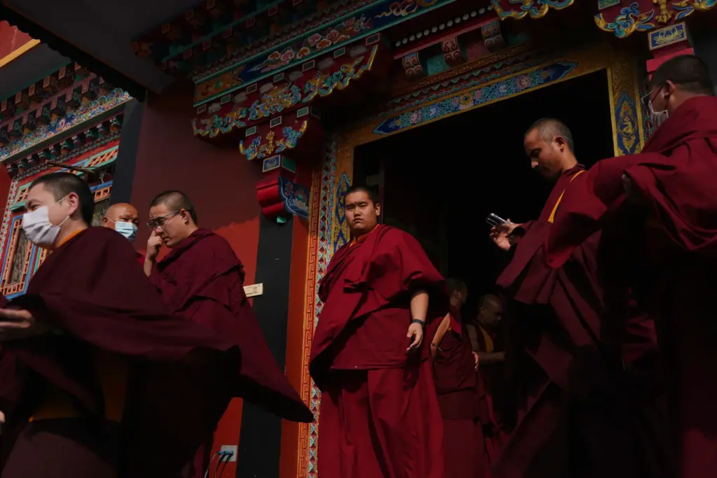 U.S.-born Buddhist lama Jalue Dorje walks out of a prayer...