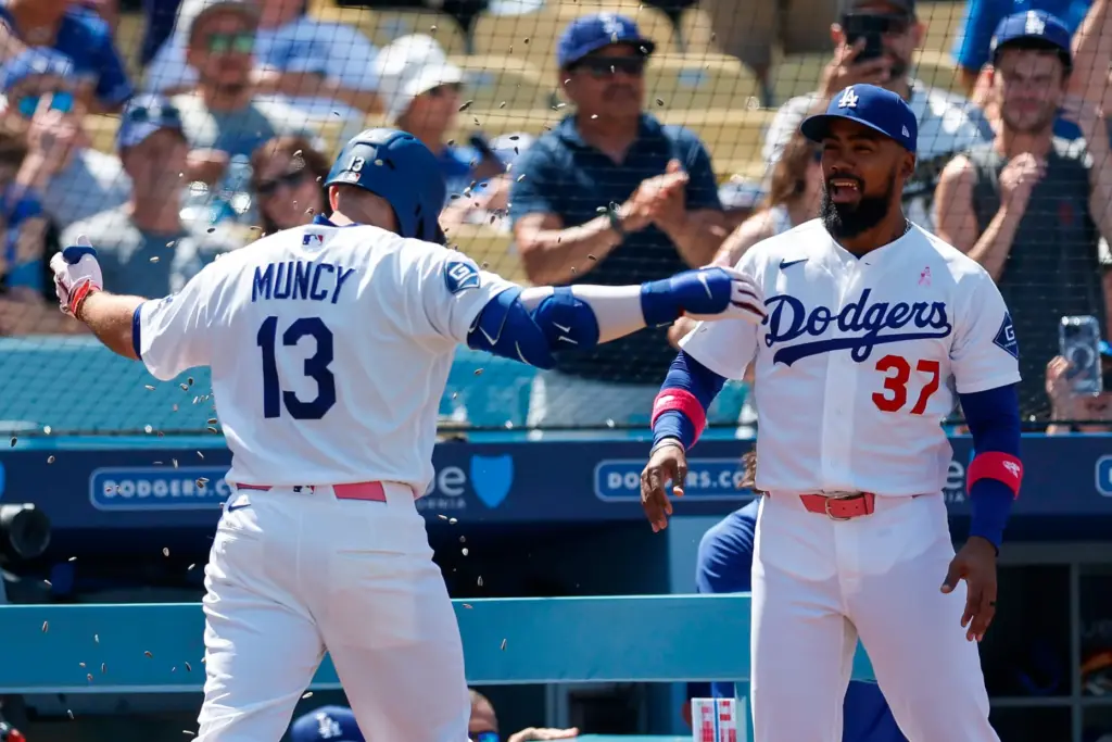 Dodgers’ Max Muncy (13) has sunflower seeds thrown on him...