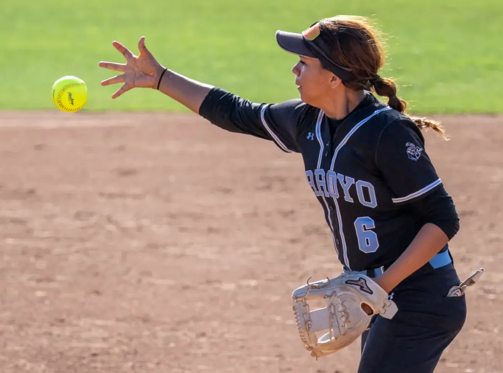 Arroyo shortstop Melanie Borgen fields the ball with her bare...