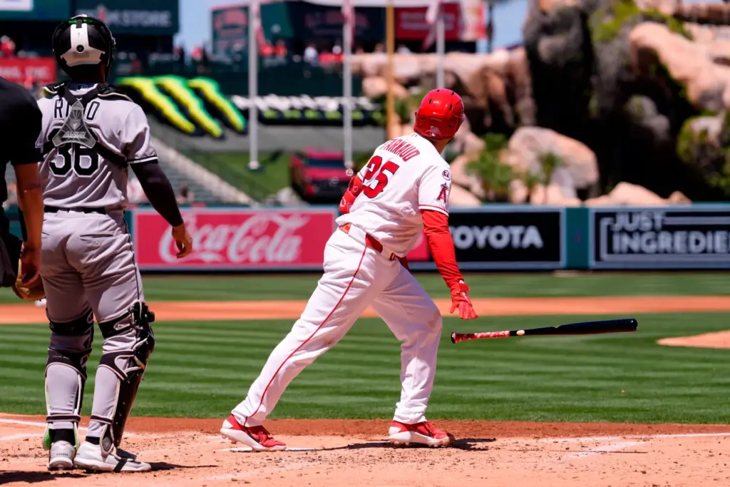 The Angels’ Travis D’Arnaud, right, drops his bat as he...