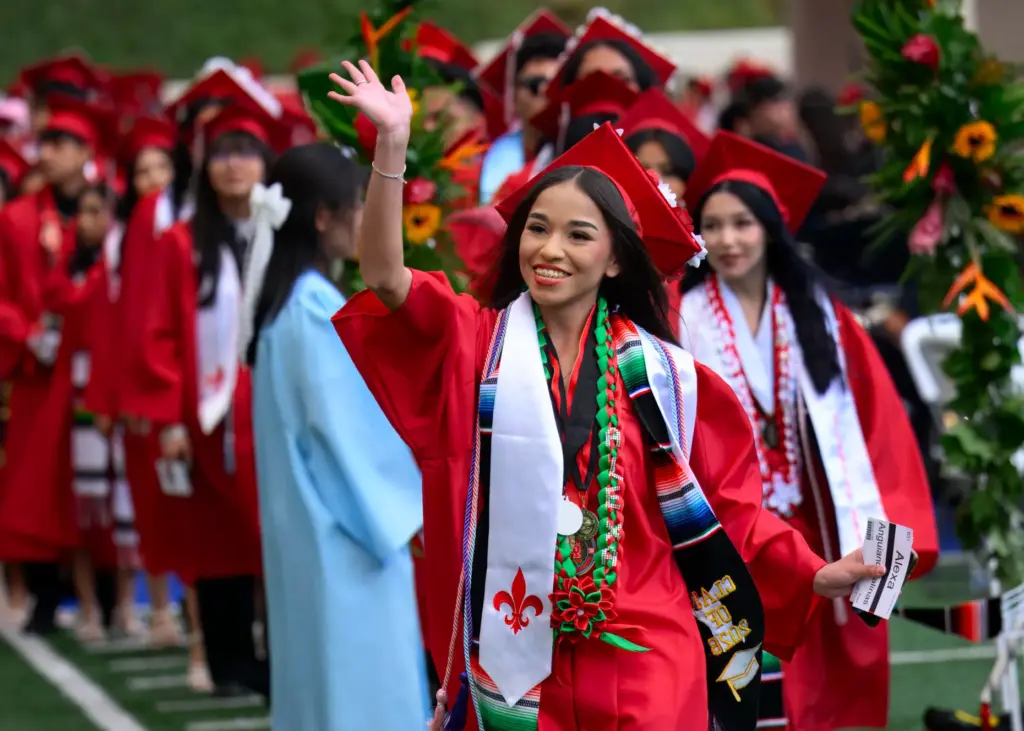 Alexa Anguiano Salinas waves as she walks onto Eddie West...