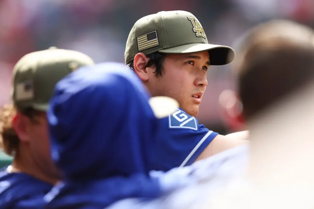 Dodgers’ Shohei Ohtani looks on from the dugout during the...