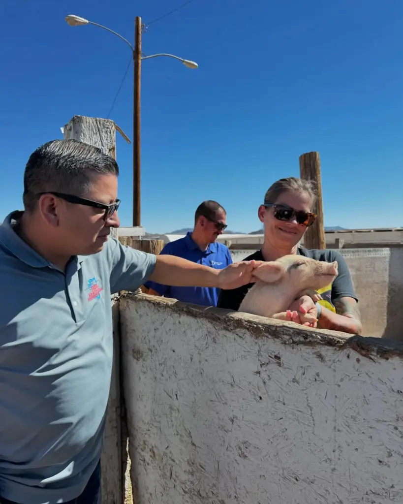 San Bernardino County Supervisor Jesse Armendarez pets a pig at...