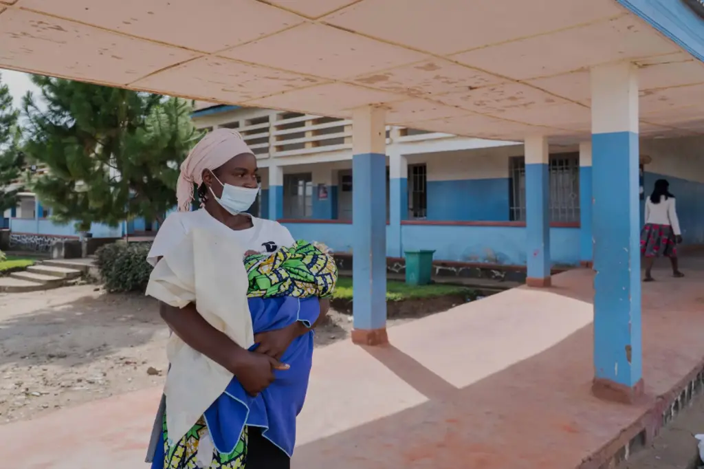 A woman wearing a protective mask stands in the corridor of a hospital in Bunia, Congo.