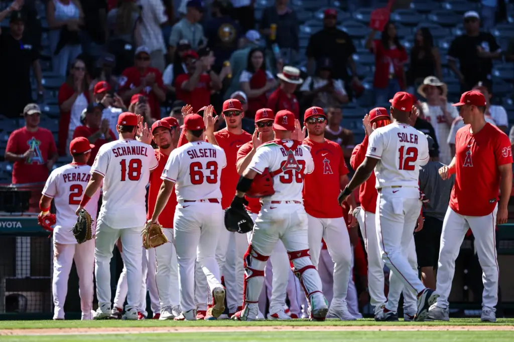 Angels players and coaches celebrate after their 8-2 victory over...