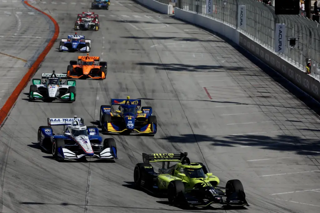 IndyCars approach the first turn off Shoreline Drive at the...