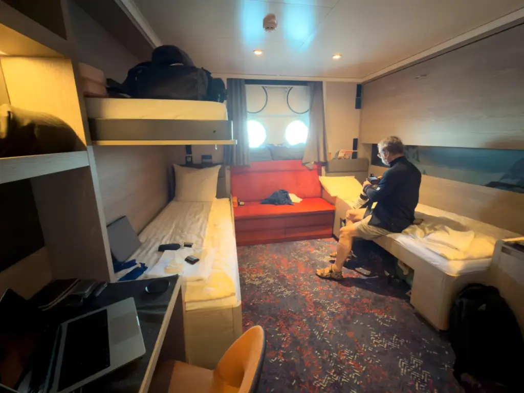 A passenger checks his camera inside his cabin on the...