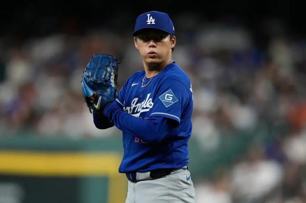 Dodgers starting pitcher Yoshinobu Yamamoto prepares to throw to the...